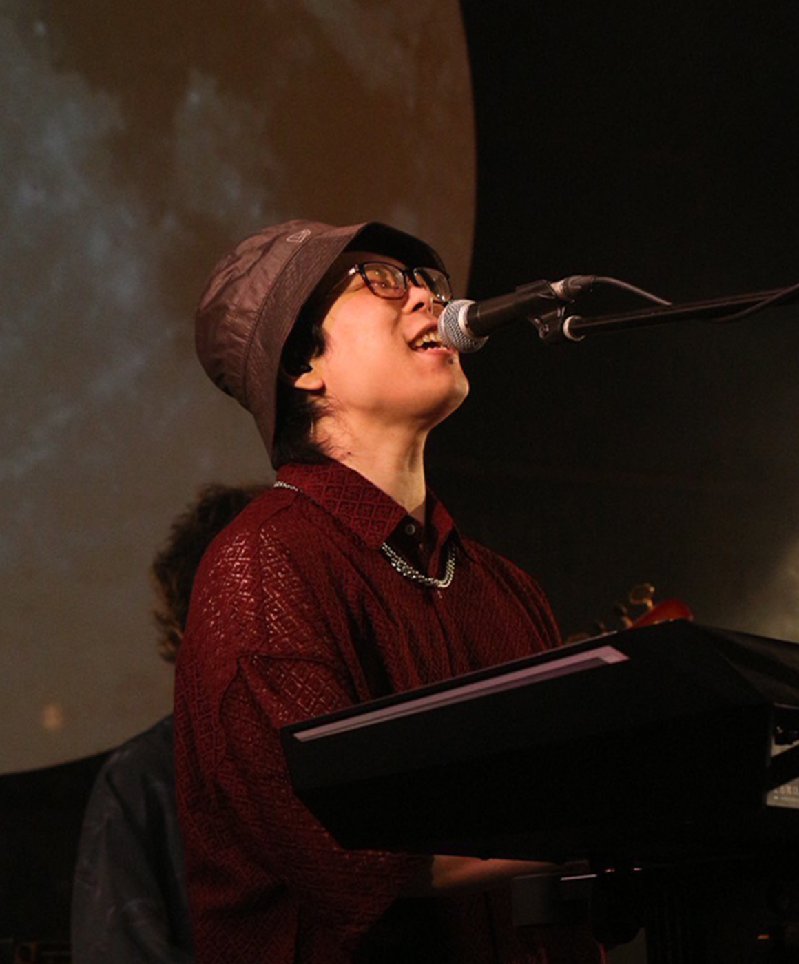 WiS playing keyboard on stage